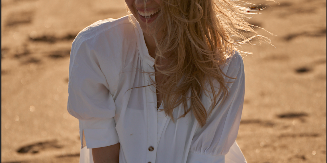 woman on beach smiling and healthy